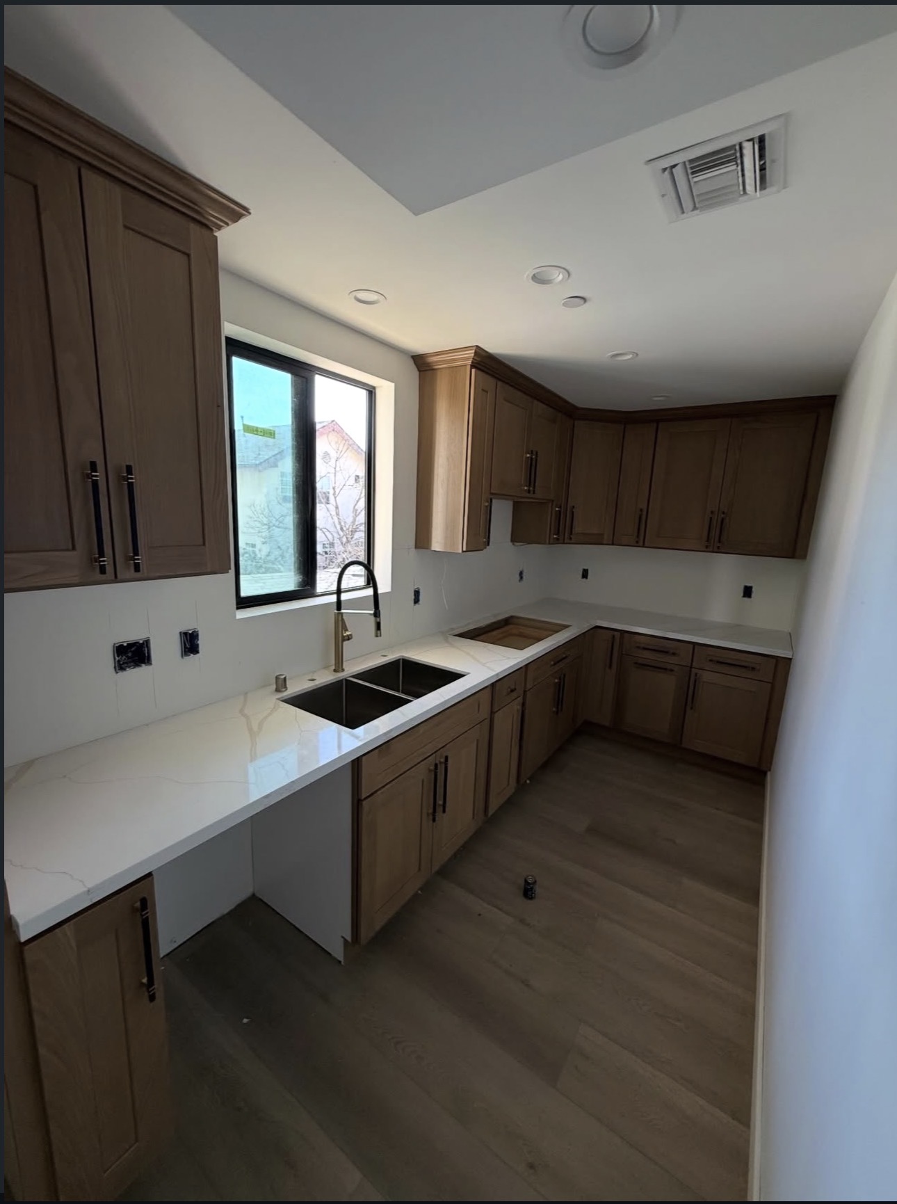New kitchen with quartz counters and undermount sink plumbed and connected.