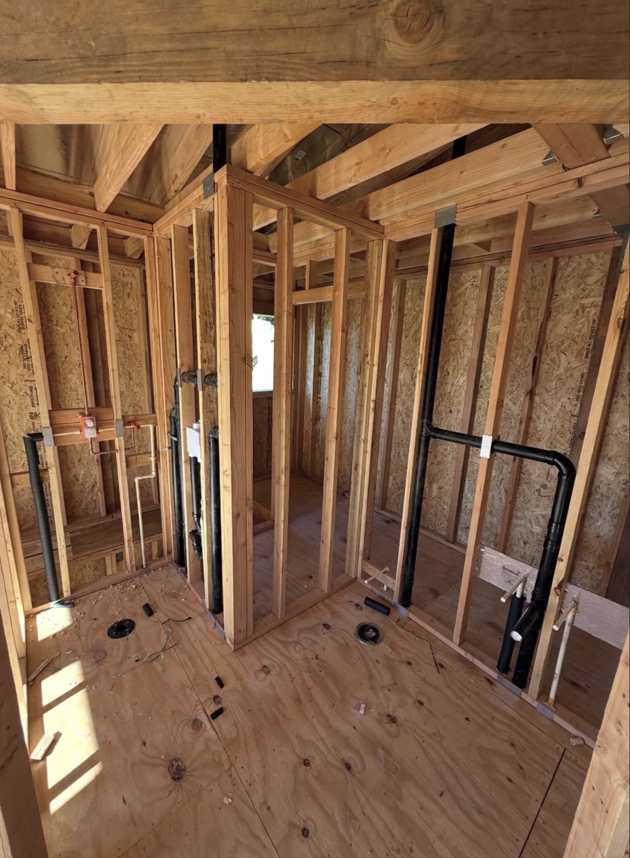 Bathroom rough-in plumbing with drain, waste, vent and supply lines in an open framed wall.